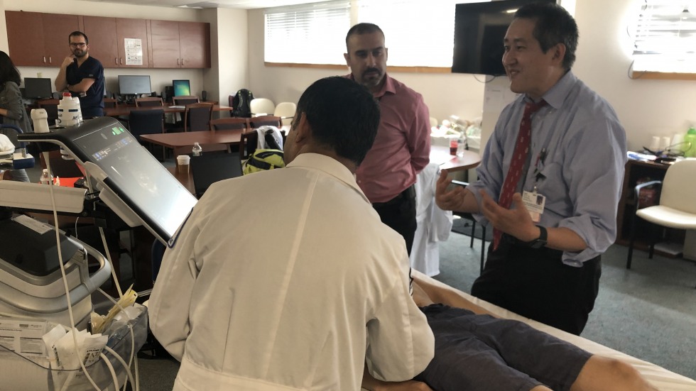 doctors practicing ultrasound on model patient